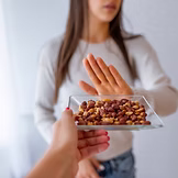 A woman turning away food due to a food intolerance gut health dietitian nutritionist - IN GOOD NUTRITION