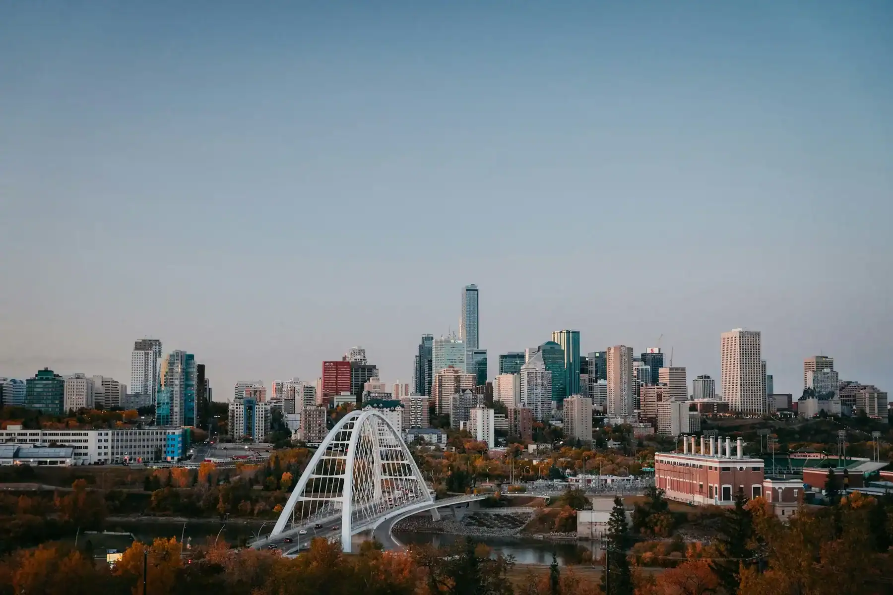 Edmonton's skyline and iconic river bridge set against autumn colours, representing In Good Nutrition's commitment to empowering Edmontonians with personalized dietitian support.