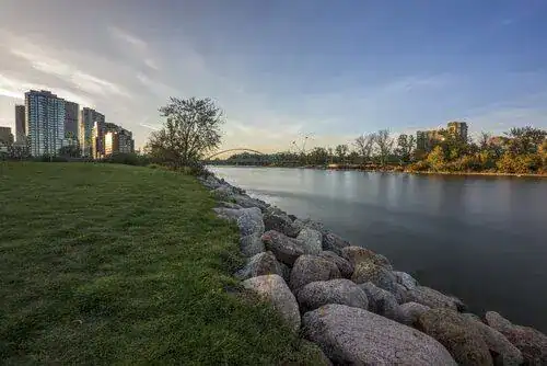 Saskatoon's rocky riverside skyline in soft sunlight, representing In Good Nutrition's commitment to empowering Saskatonians with personalized dietitian support.
