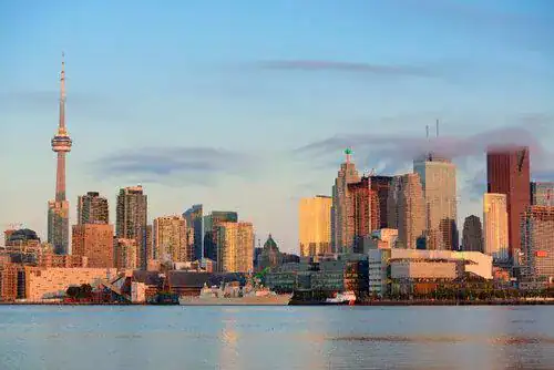 Toronto's sunset skyline with the CN Tower reflected in calm water, representing In Good Nutrition's commitment to empowering Torontonians with personalized dietitian support.