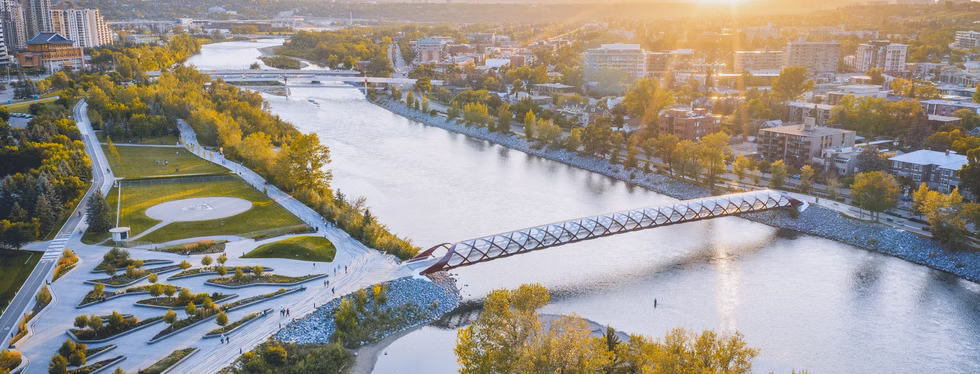 Calgary's sunset skyline along the river and pedestrian bridge, representing In Good Nutrition's commitment to empowering Calgarians with personalized dietitian support.