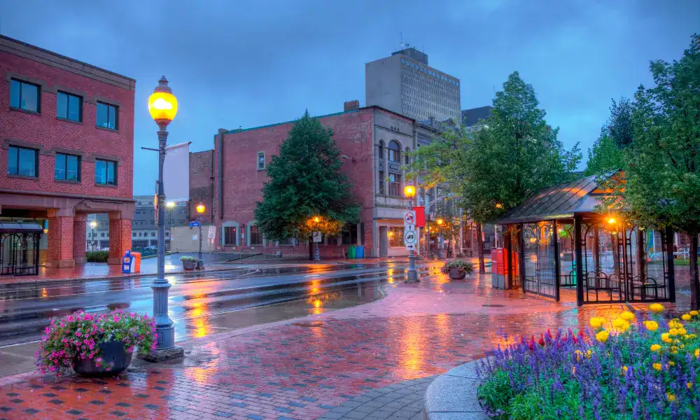 Moncton's rain-slicked streets glowing under lamplight, representing In Good Nutrition's commitment to empowering Monctonians with personalized dietitian support.