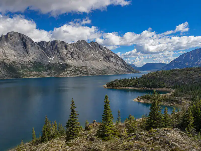 Northwest Territories' clear lake ringed by rocky peaks and pine, representing In Good Nutrition's commitment to empowering Northwest Territories residents with personalized dietitian support.